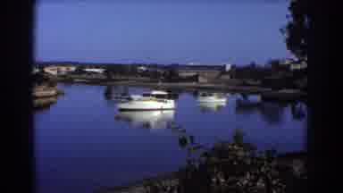 Sydney Australia (1967): Boat In A Blue River Next To Land With Grassy Terrain