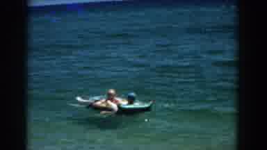Florida (1957): View Of Two People On Blue Inflatable Raft In Blue Lake Water On A