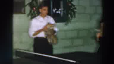 Wheeling Ohio (1957): Man Holds Small Dog Next To Two Women Playing Doubles Ping