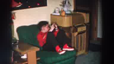 Wheeling Ohio (1957): Young Boy In Red Shirt And Shoes Getting Up From Green Chair