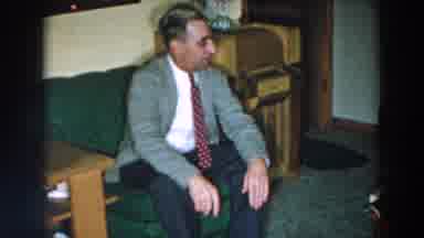 Wheeling Ohio (1957): A Guy In A Blazer And A Tie Sitting On A Couch Talking To