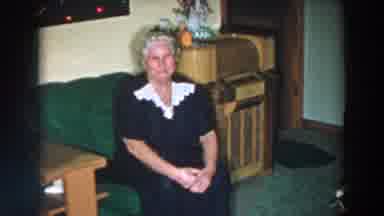 Wheeling Ohio (1957): Elder Woman Sits On The Couch And Talks To The Camera In A
