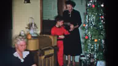 Wheeling Ohio (1957): Woman Wearing Black Dress Escorts Boy Wearing Red Pajamas