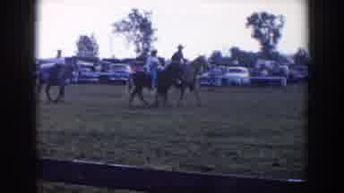 Wheeling Ohio (1957): Three People Riding Horses Past Parked Cars On A Clear Day