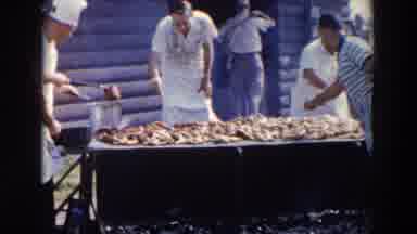 Wheeling Ohio (1957): Multiple Men Cooking And Turning Meat On An Open Barbecue