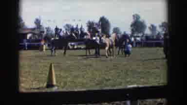 Wheeling Ohio (1957): Horse Standing Near Spectators On Grass With Racers On Backs