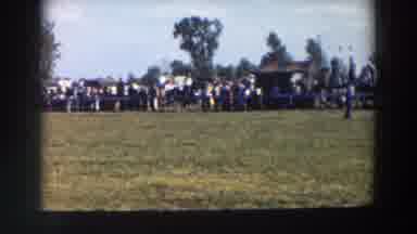 Wheeling Ohio (1957): Four People Ride Horse Around White Fence On A Sunny Day
