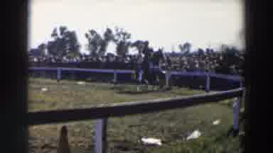 Wheeling Ohio (1957): A Person Riding A Horse Around A Pen While People Watch From