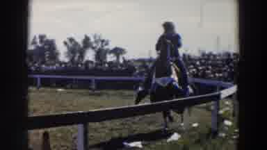 Wheeling Ohio (1957): Person Wearing White Hat Rides Horse Around White Wooden