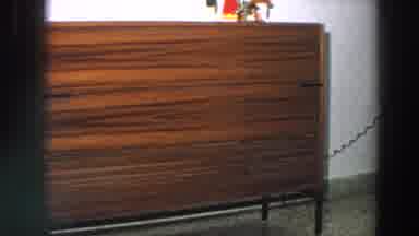 Italy (1958): View Of Brown Wooden Console Table And Woman Wearing Grey Vest