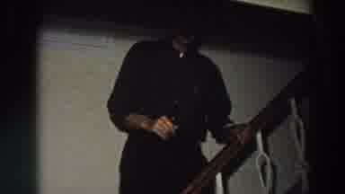 Italy (1958): Man Wearing Grey Shirt And Black Pants Descends Staircase Sideways