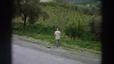 Italy (1958): Man Walks Into Grass Field During An Overcast Day And Appears To