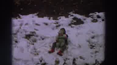 Italy (1958): Boy Wearing Red Boots Sprinkles Snow On Top Of Baby Wearing Green
