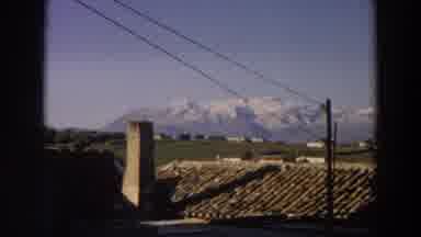 Italy (1958): View Of Snow Covered Mountains And Green Field On A Sunny Day