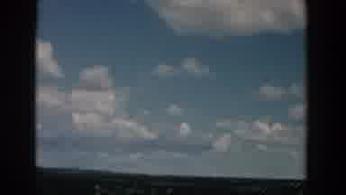South Carolina (1958): Driving Past A Field On A Cloudy Day With Blue Sky