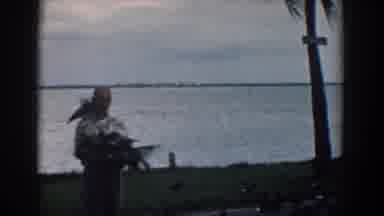 South Carolina (1958): A Man And Young Boy Feeding Hundreds Of Birds By A Lake