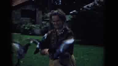 South Carolina (1958): Flock Of Pigeons Fly Toward Woman Wearing Brown Shirt And