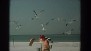 Yorktown Virginia (1958): A Man Wearing Only Shorts And A Hat Pours Food From A