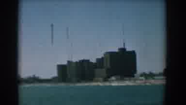 Yorktown Virginia (1958): View Of Grey Building Next To Blue Ocean Water On A