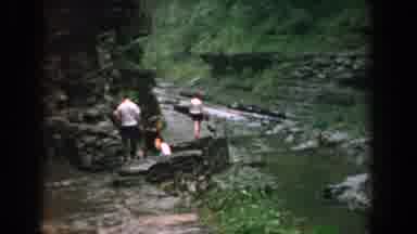 Yorktown Virginia (1958): Three People Walking On Dark Grey Stone Path On A Clear