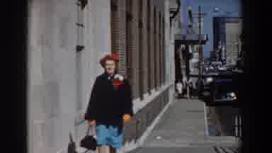 Yorktown Virginia (1958): Woman Wearing Red Hat Walks Down Street On A Bright
