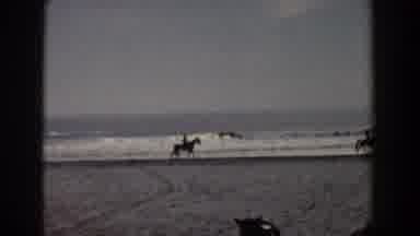 Yorktown Virginia (1958): Two Men On Horses Walk Trot Along Waves At Beach