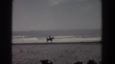 Yorktown Virginia (1958): Person Rides Horse On Beach With Woman Wearing Red Hat