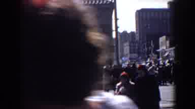 Yorktown Virginia (1958): Man Wearing Tan Coat Walks With Crowd On A Sunny Day