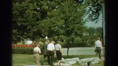 Florida (1959): Crowd Entering House Walks Through Stone Walkway Crossing Bridge