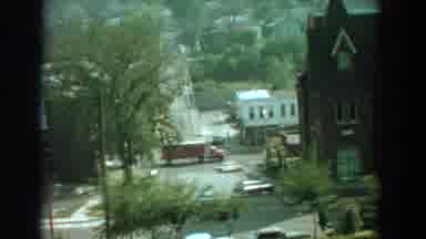Florida (1959): Two Cars Follow Yellow Truck On A Bright Sunny Day