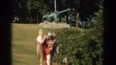 Florida (1959): People Posing Near A Memorial Statue