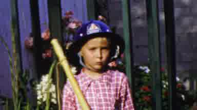 Paramus New Jersey (1959): Child Wearing Fireman Helmet With A Baton In One Hand