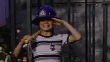 Paramus New Jersey (1959): Adorable Child In Oversized Helmet And A Bat Salutes At