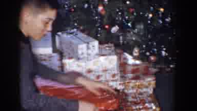 Bel Air Maryland (1960): Young Boy Opening Wrapped Christmas Present Near