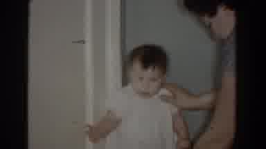 Bel Air Maryland (1960): Baby Wearing Red Pants And White Shirt Stand On Red Table