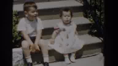 Bel Air Maryland (1960): Little Boy Kisses A Girl On Cheek At Staircase And She Is