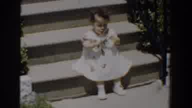 Bel Air Maryland (1960): A Baby Girl In A Dress Sits On Outdoor Steps And A Young