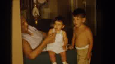 Bel Air Maryland (1960): Woman With Child On Her Lap Waves The Child Arms