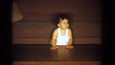 Bel Air Maryland (1960): A Cute Baby Standing Holding On To A Table In A Room