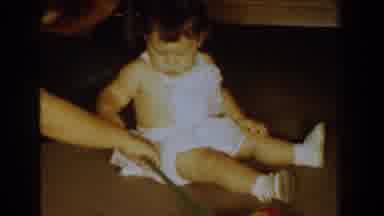 Bel Air Maryland (1960): A Toddler With A White Outfit And Shoes Sits And Plays