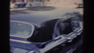 Bel Air Maryland (1960): Baby Waves Through Window Of Black Parked Car On A Clear