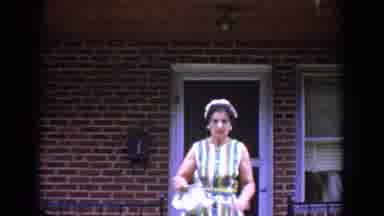 Bel Air Maryland (1960): Woman Wearing Striped Dress And Hat Walks Down Steps With