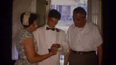Bel Air Maryland (1960): A Mom And A Dad Gaze At Their Sons Hand As He Shows Them