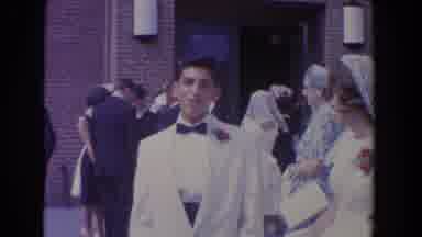 Bel Air Maryland (1960): Couple Wearing White Formal Wear Stand In Front Of Brown