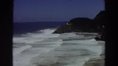 California (1964): Water Gushing To The Shore Of The Ocean Big Rocks To The Right