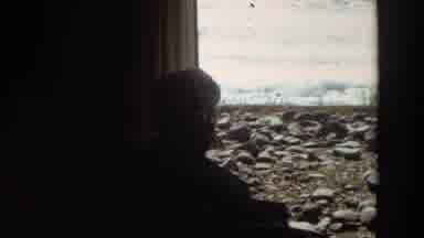 California (1964): Old Woman Sitting Next To Round Table Staring Out Window To