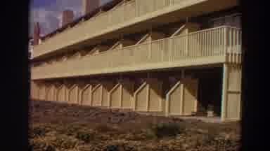 California (1964): Video Of A Woman Standing In Front Of A Multi-Story Building