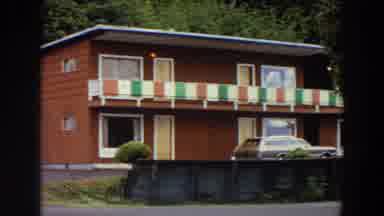 California (1964): View Of Red And Yellow Building On A Clear Day