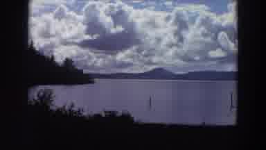 California (1964): A Placid Body Of Water Is Surrounded By Mountains And Trees