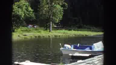 California (1964): Single Boat Sits By A Dock On A Lake Empty